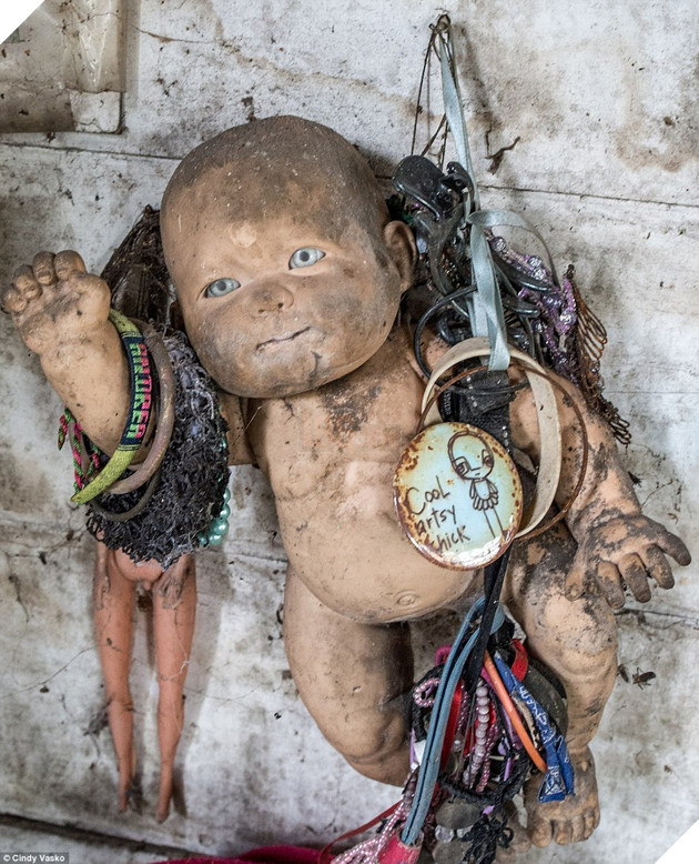 Memento: Tourists have added their own personal touches to the terrifying dolls he left behind, and even leave donations to his family