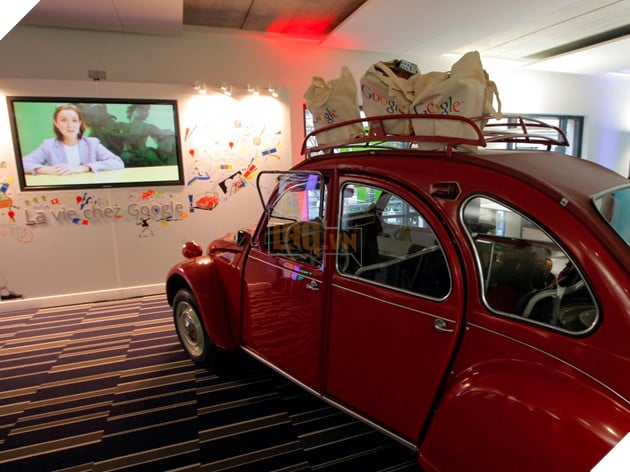 The Paris office has a shiny red Citroen 2CV car inside.