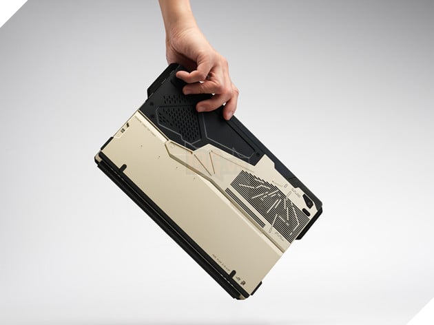 A hand is lifting a sleek, black ROG Plow Z13 laptop, featuring a distinctive geometric pattern.AI-generated content may be incorrect.